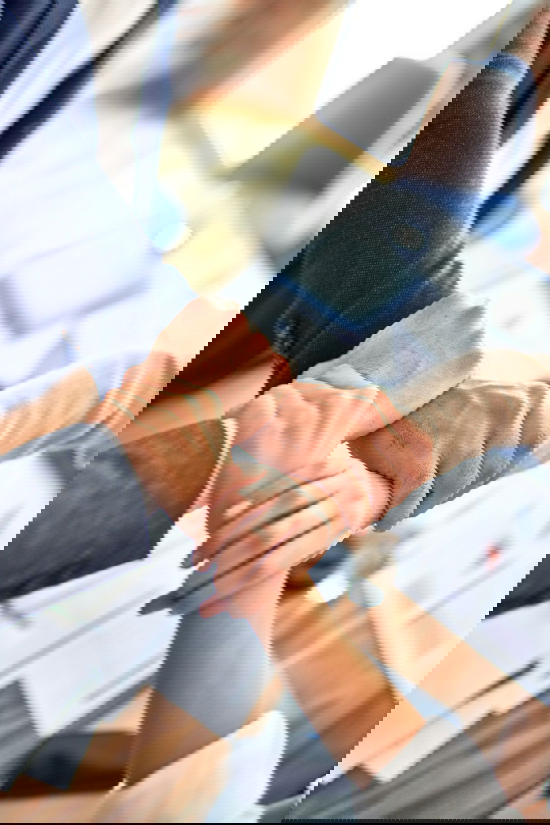 person in black long sleeve shirt holding persons hand