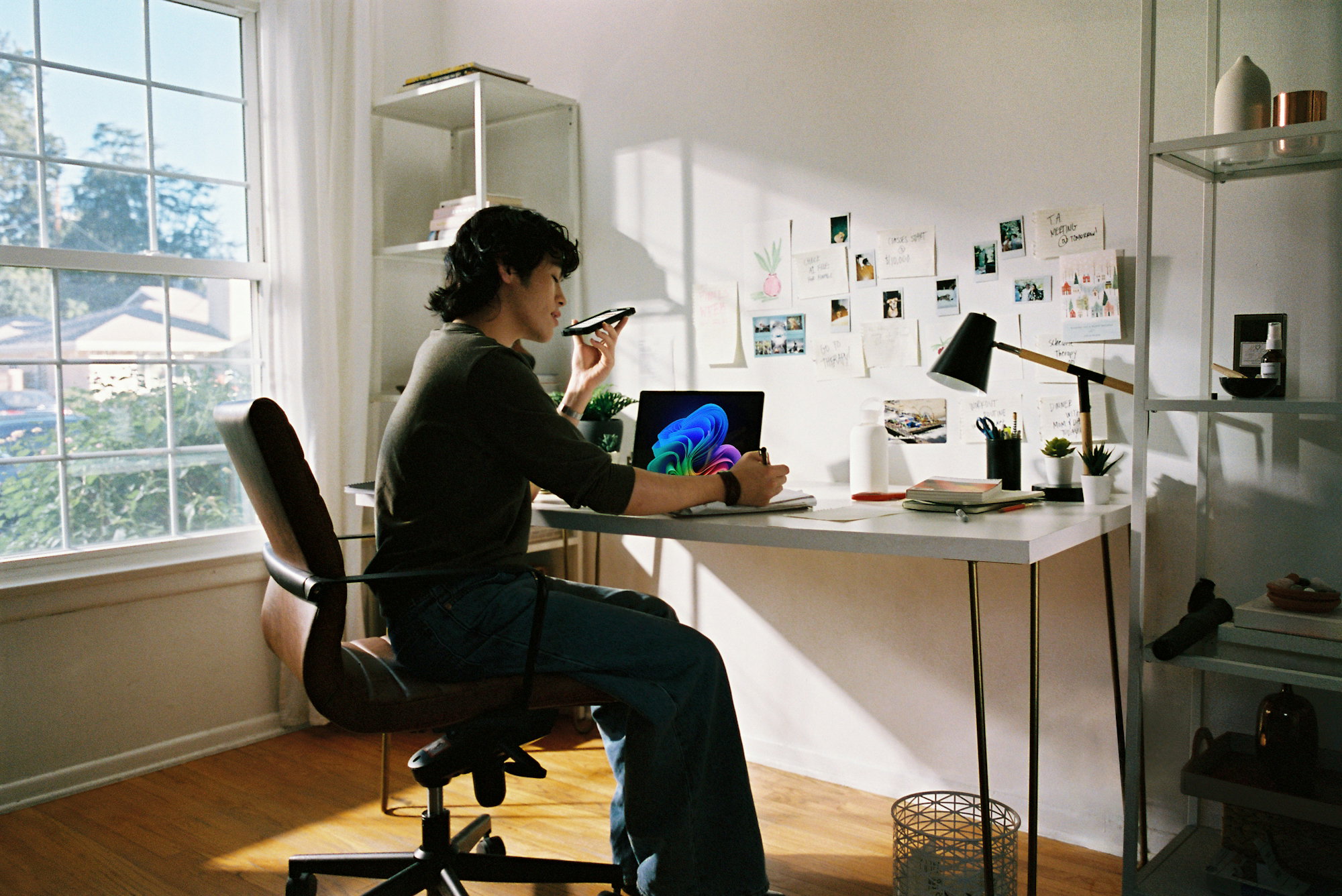 person-working-at-desk-with-laptop-and-phone-.jpg Person working at desk with laptop and phone.